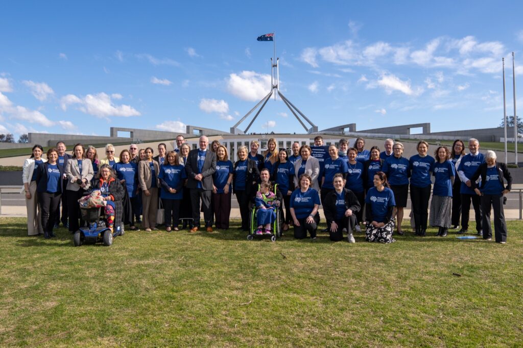 Alliance members and supporters in blue t-shirts outside Parliament House, Canberra
