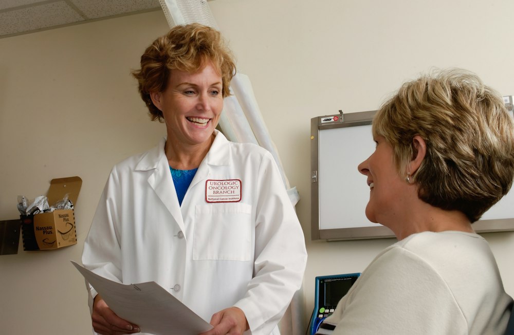 A clinician talking with a patient in a consulting room